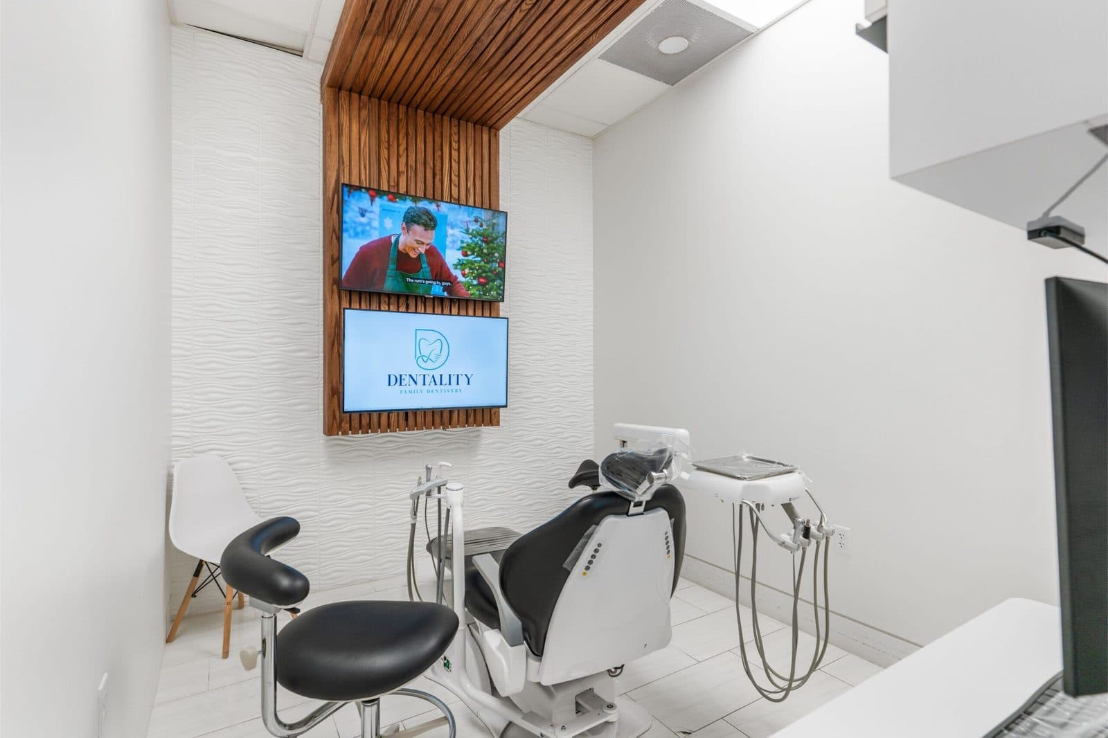 Treatment room with a ceiling-mounted TV for patient comfort